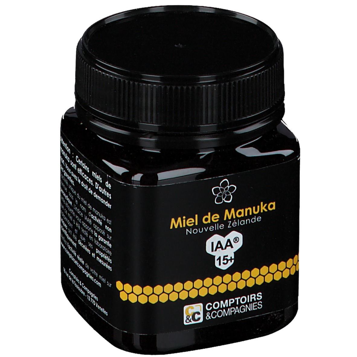 Schwarzes Glas mit Honig. Aufschrift: Miel de Manuka Nouvelle Zélande IAA 15+. Logo Comptoirs & Compagnies. Schwarzer Deckel.