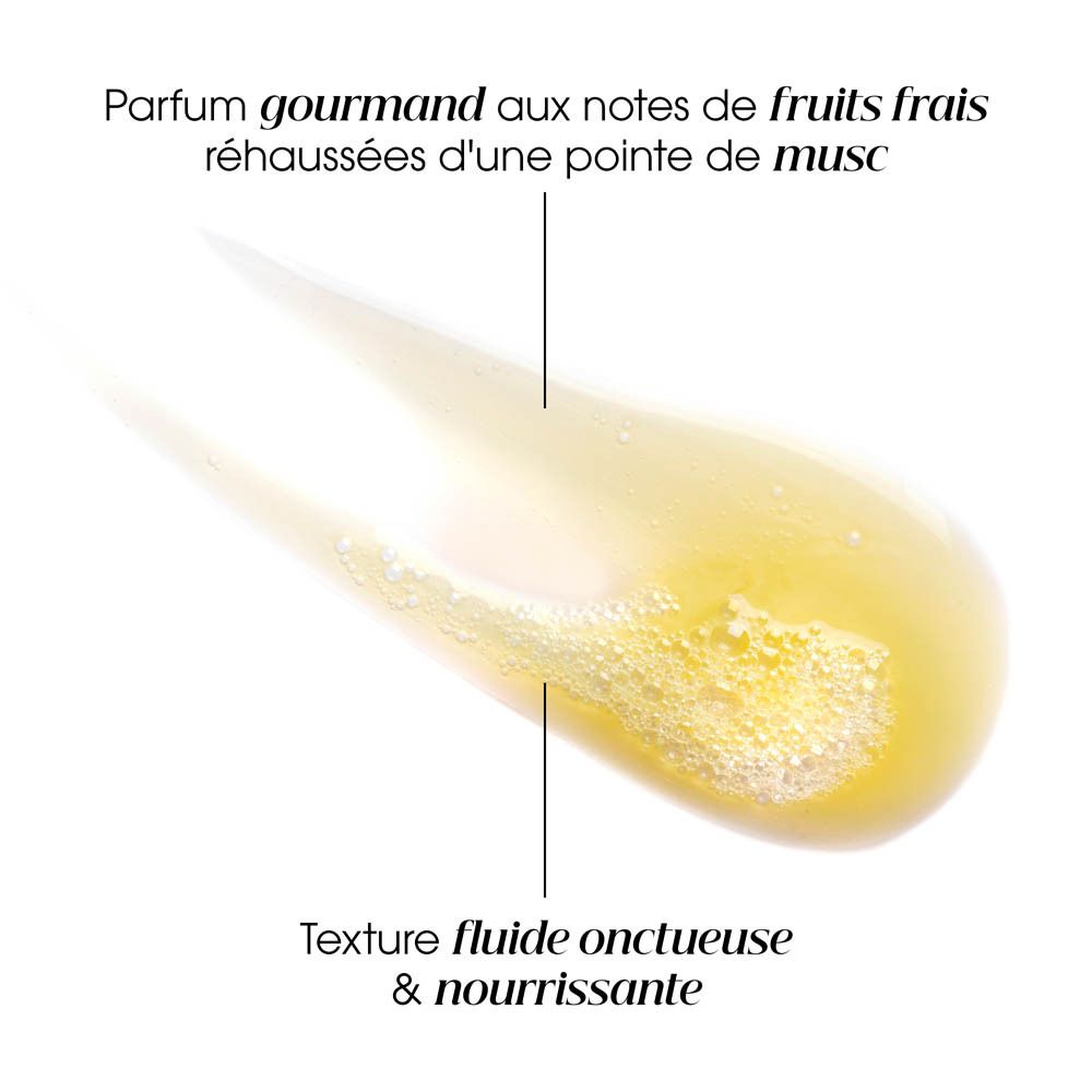 Gros plan d'une texture crémeuse jaune. Texte : parfum aux notes fruitées, texture fluide et nourrissante.
