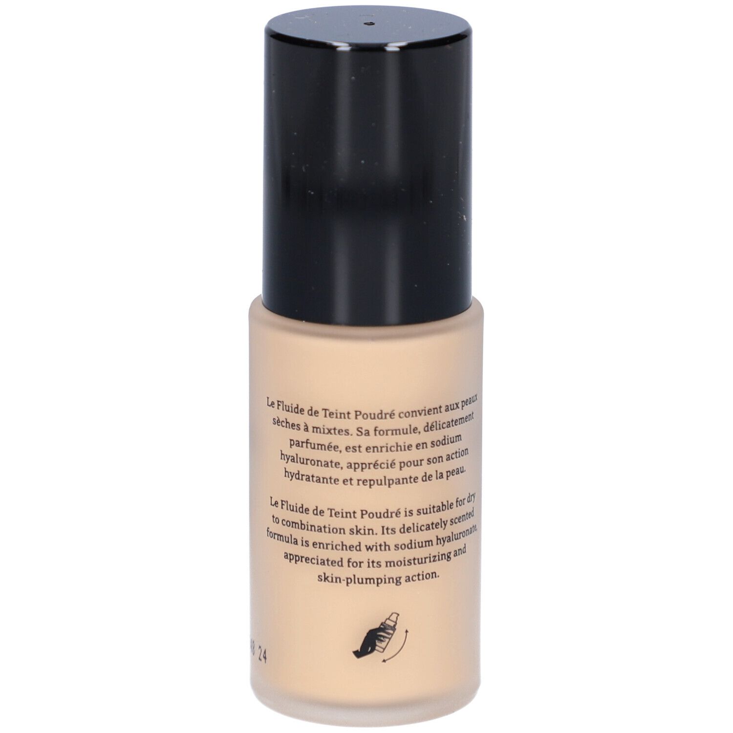 Fond de teint fluide beige dans un flacon cylindrique à bouchon noir. Texte sur le flacon.