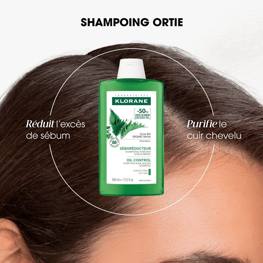 Femme souriante aux longs cheveux, avec "-50% d'excès de sébum" à côté.