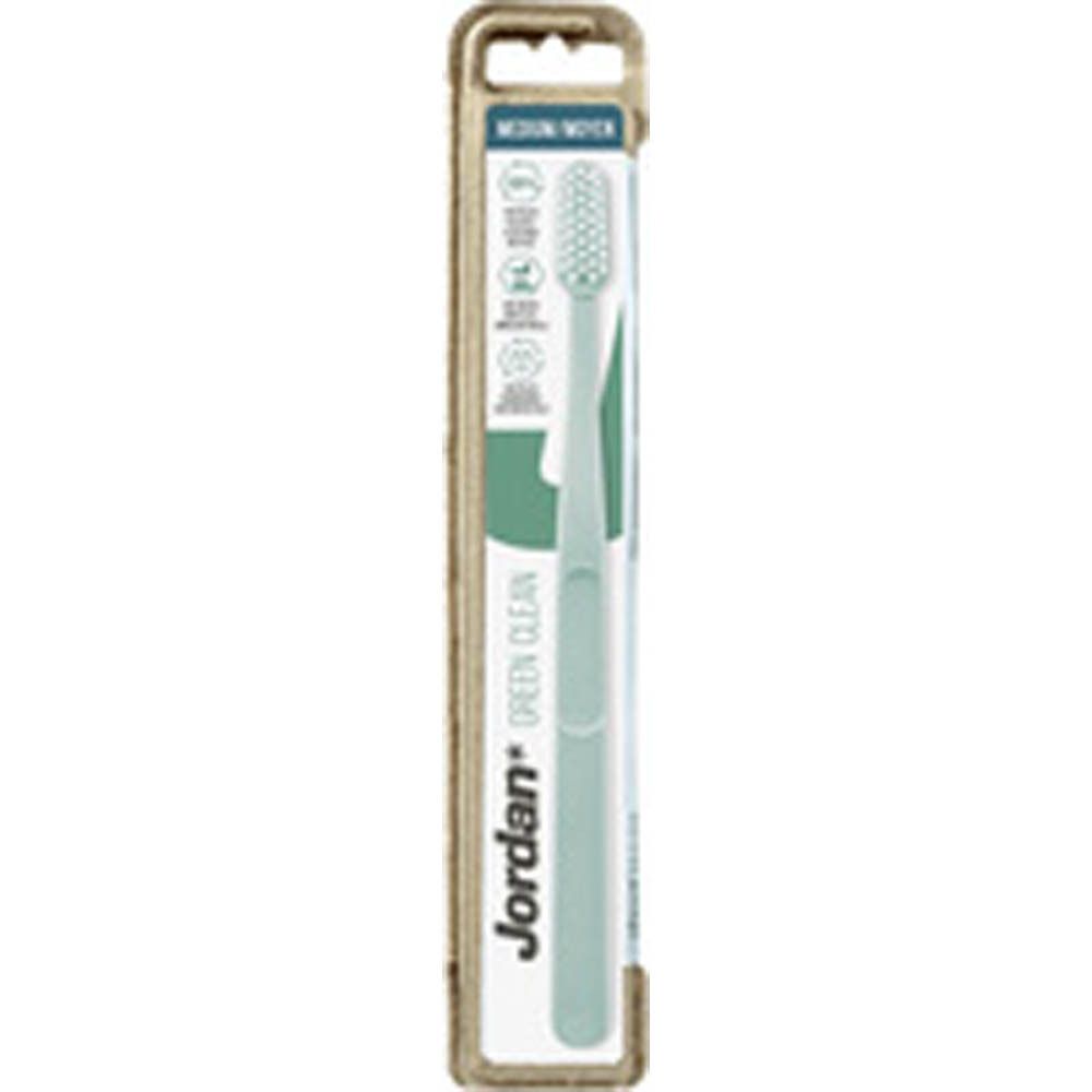 Brosse à dents rose dans un emballage en carton. Inscription : Jordan Green Clean, Medium. Emballage avec symboles de recyclage.
