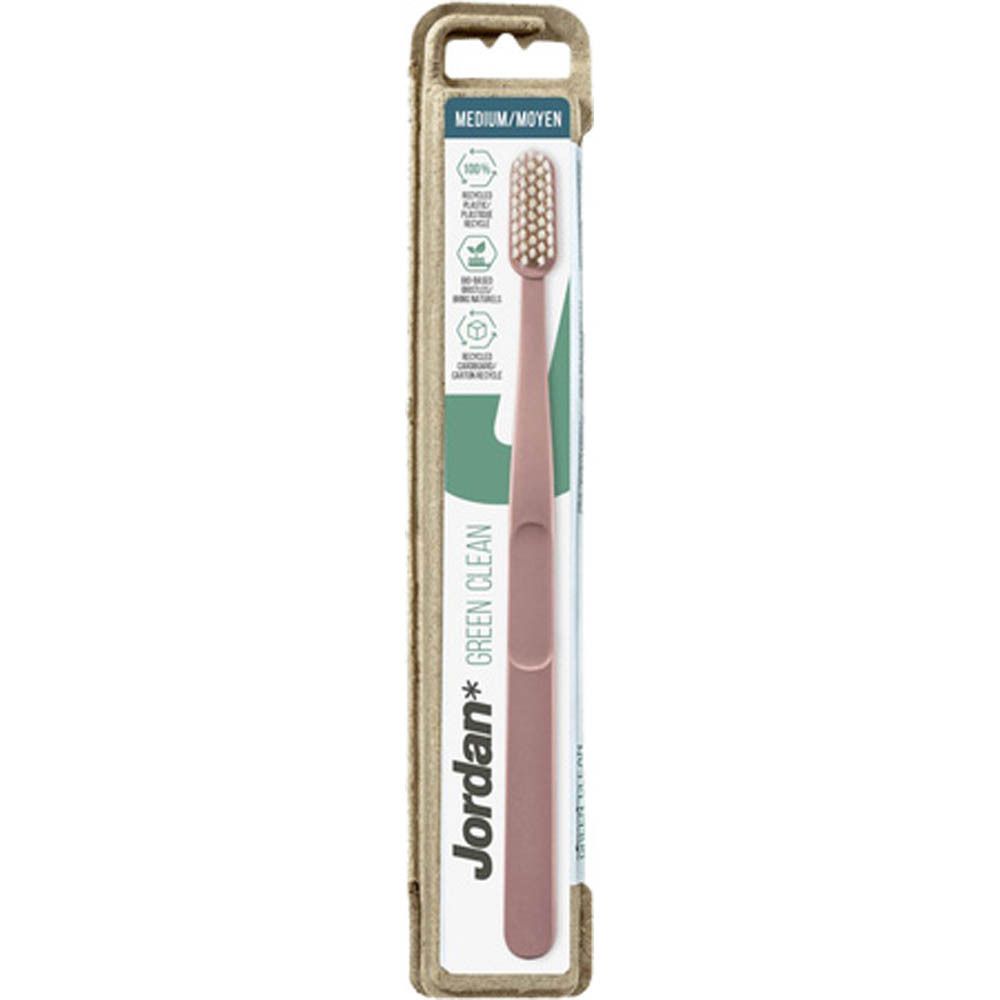 Brosse à dents verte dans un emballage en carton. Inscription : Jordan Green Clean, Medium. Emballage avec symboles de recyclage.