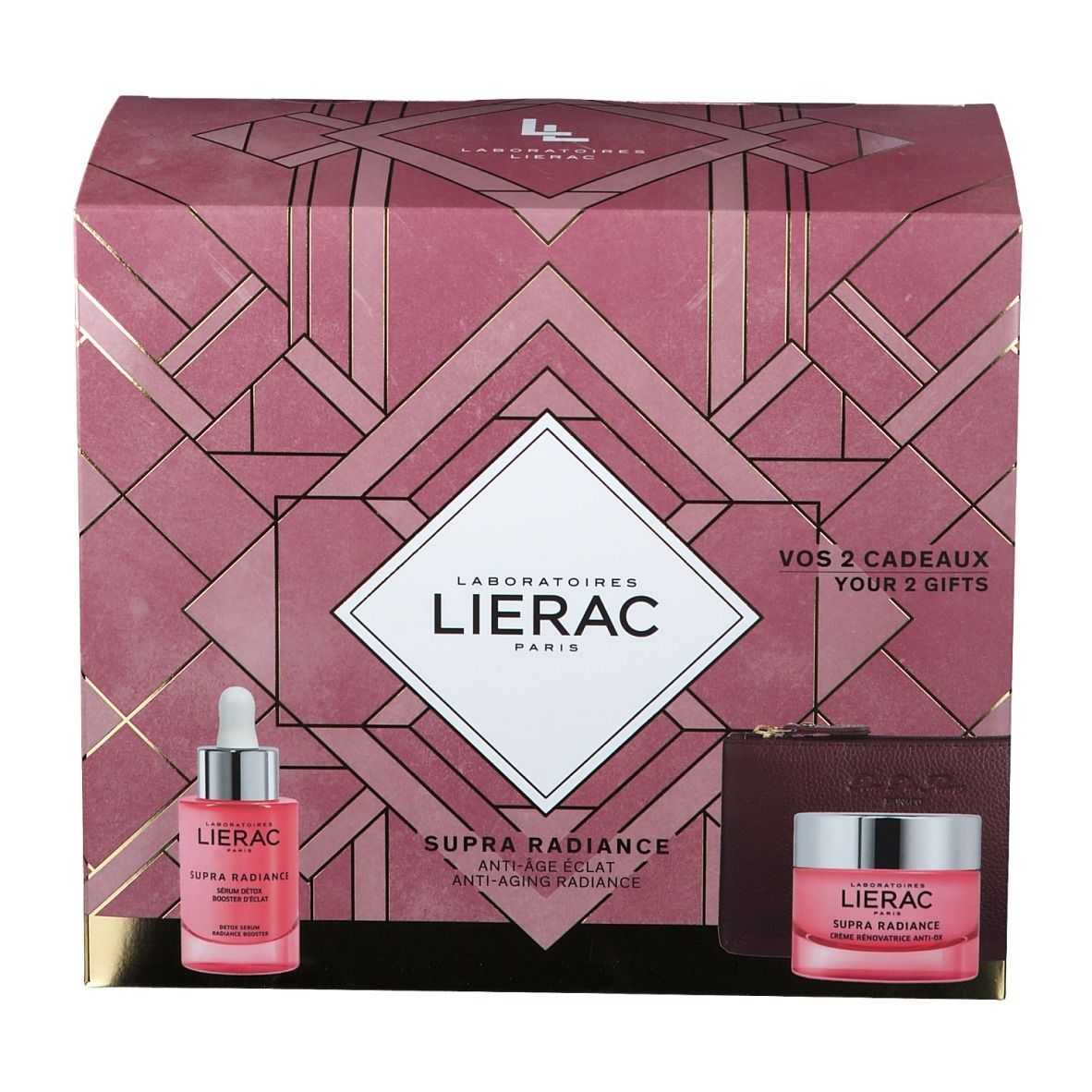 Geschenkset mit Serum, Creme und Kosmetiktasche. Rosa Verpackung mit Logo und Produktnamen. Sichtbare Schriftzüge.
