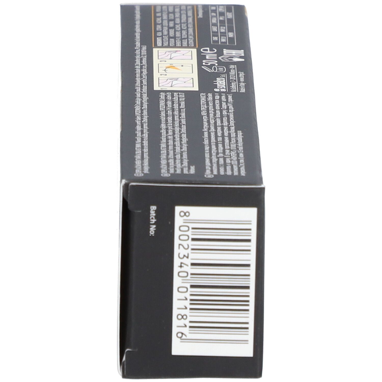 Côté de la boîte de crème dépilatoire. Boîte noire avec code-barres et numéro de lot.