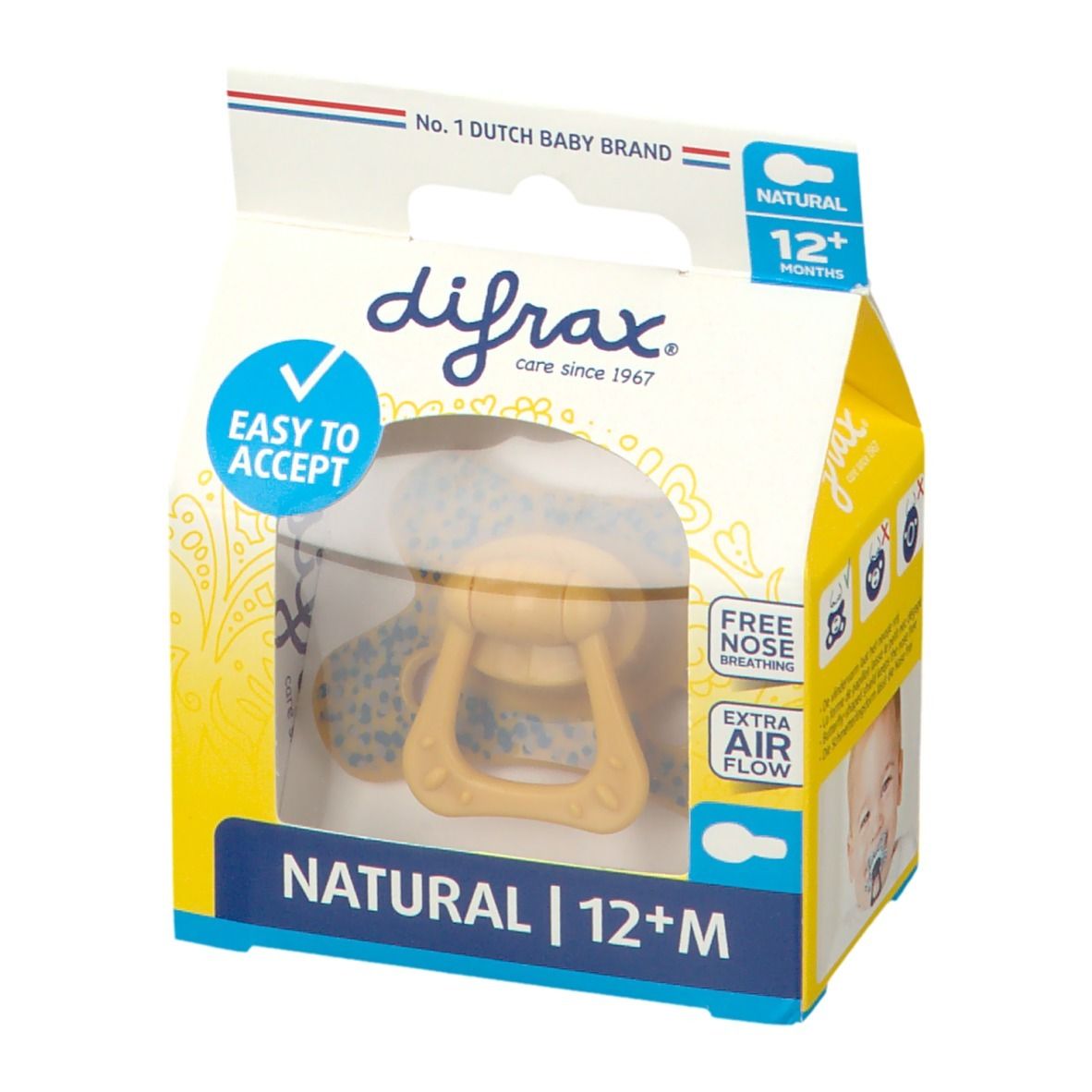 Emballage de sucette. Sucette jaune avec poignée, motif bleu. Texte: NATURAL 12+M, EASY TO ACCEPT, FREE NOSE BREATHING, EXTRA AIR FLOW.