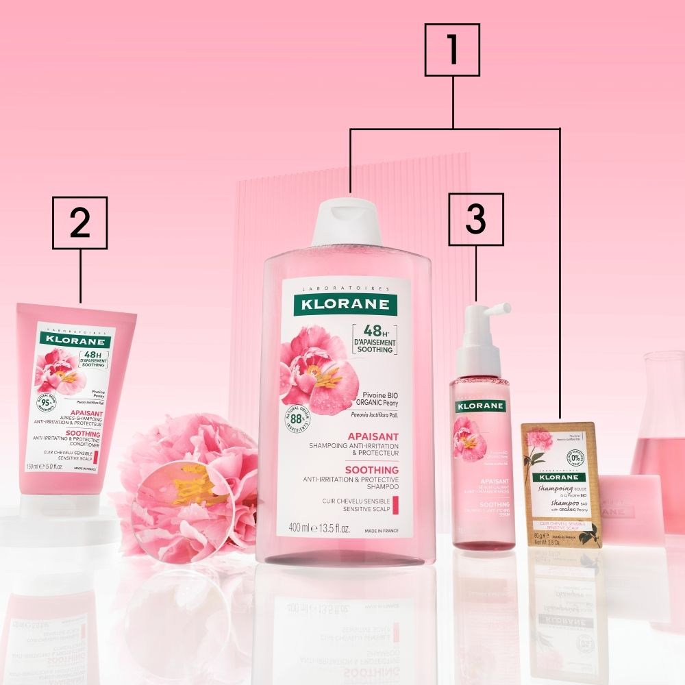 KLORANE Soin après-shampoing à la pivoine: Tube rose avec bouchon blanc, motif pivoine et informations produit à l'avant.