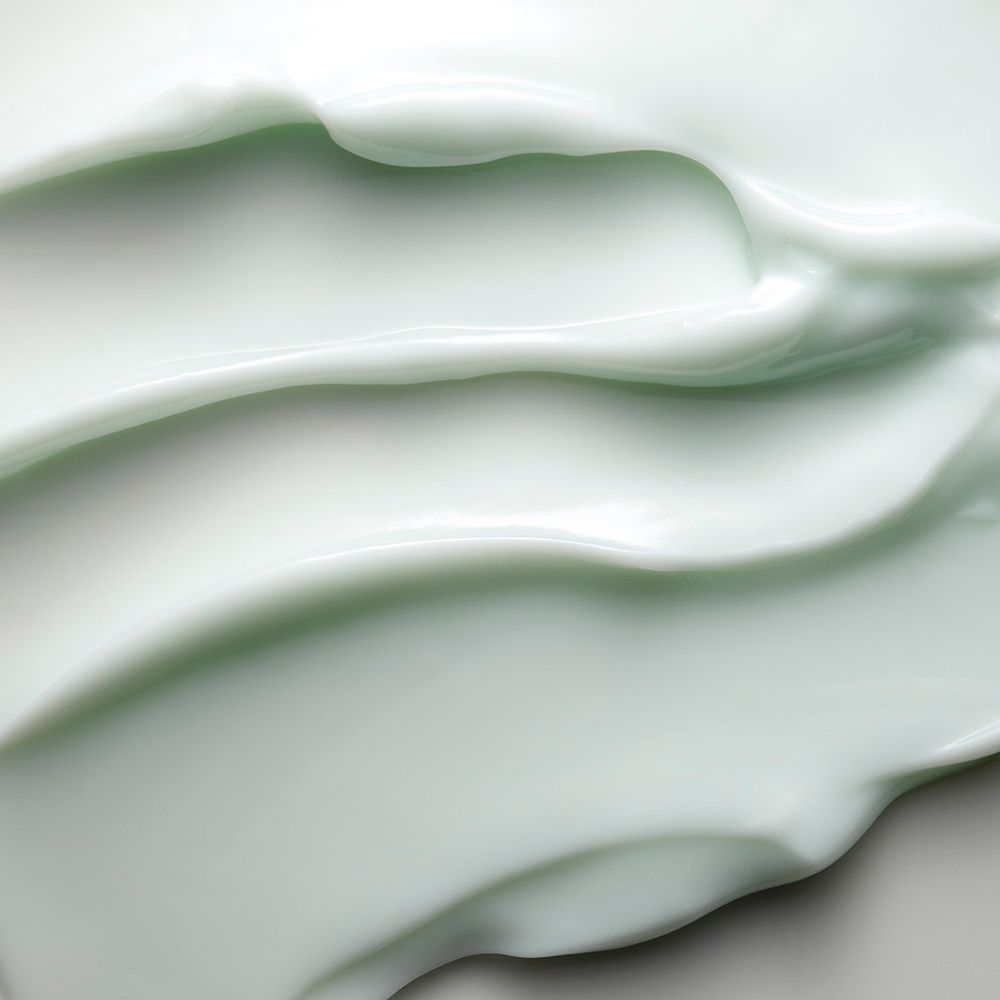 Nahaufnahme von Creme. Hellgrüne Textur.