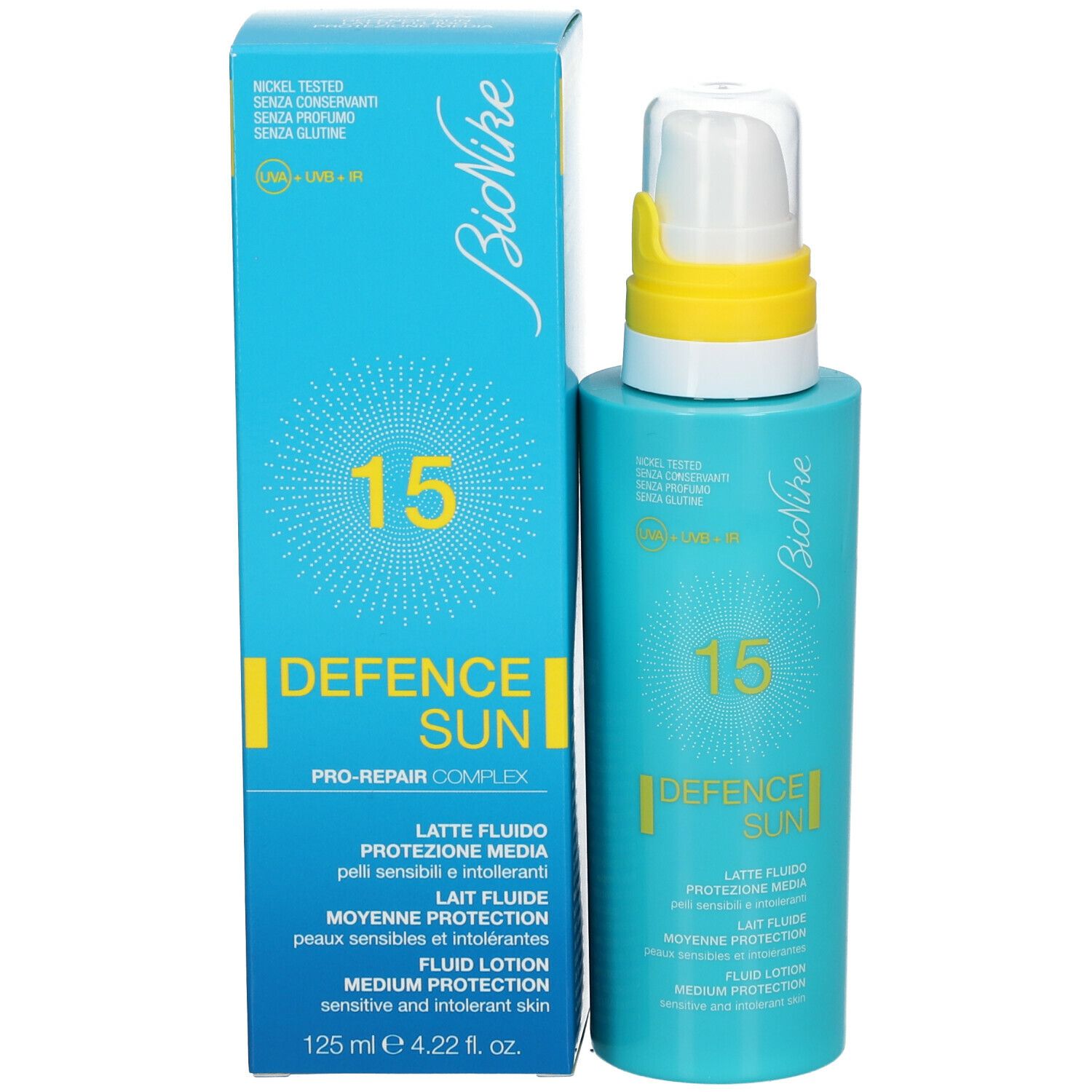 Türkisblaue Flasche und Schachtel. Aufschrift: 15, DEFENCE SUN, Lait Fluide, Protection Moyenne, Fluid Lotion. 125 ml.