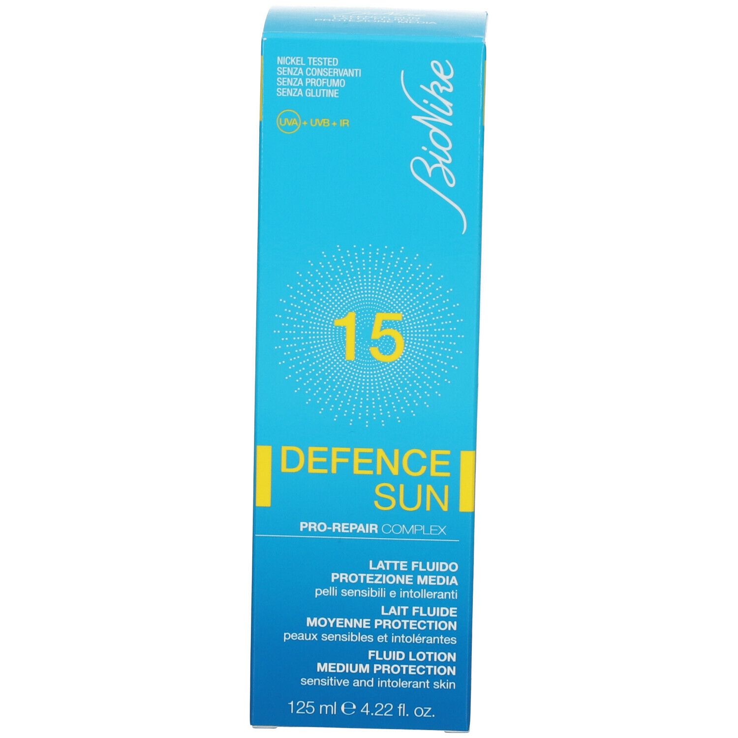 Türkisblaue Schachtel. Aufschrift: 15, DEFENCE SUN, Lait Fluide, Protection Moyenne, Fluid Lotion. 125 ml.