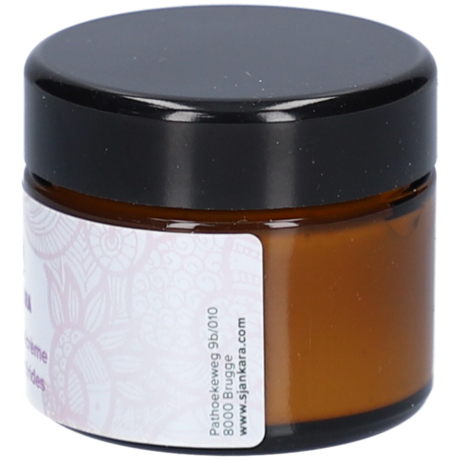 Braune Creme-Dose mit schwarzem Deckel. Aufkleber mit Text und floralem Muster. Adresse: sjankara.com.