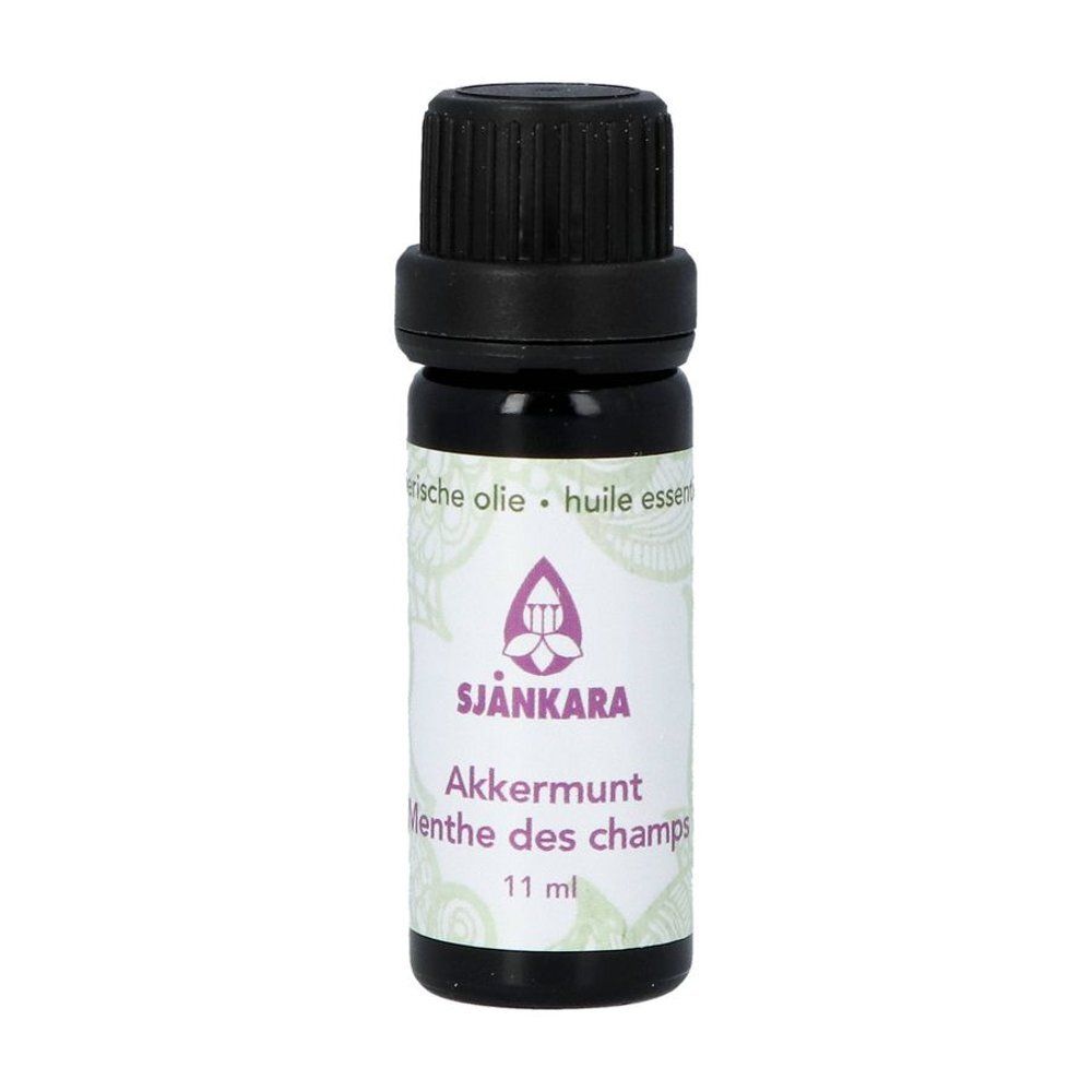 Flacon en verre brun avec bouchon noir. Étiquette avec nom du produit et logo. 11 ml.