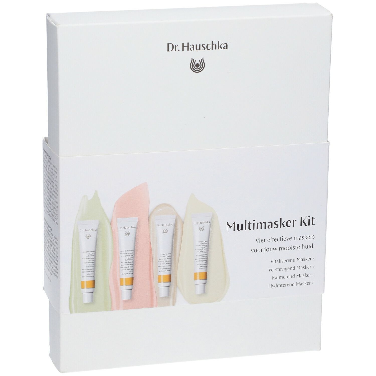Boîte blanche avec logo Dr. Hauschka et illustration du produit. Quatre tubes de masque dans l'emballage.
