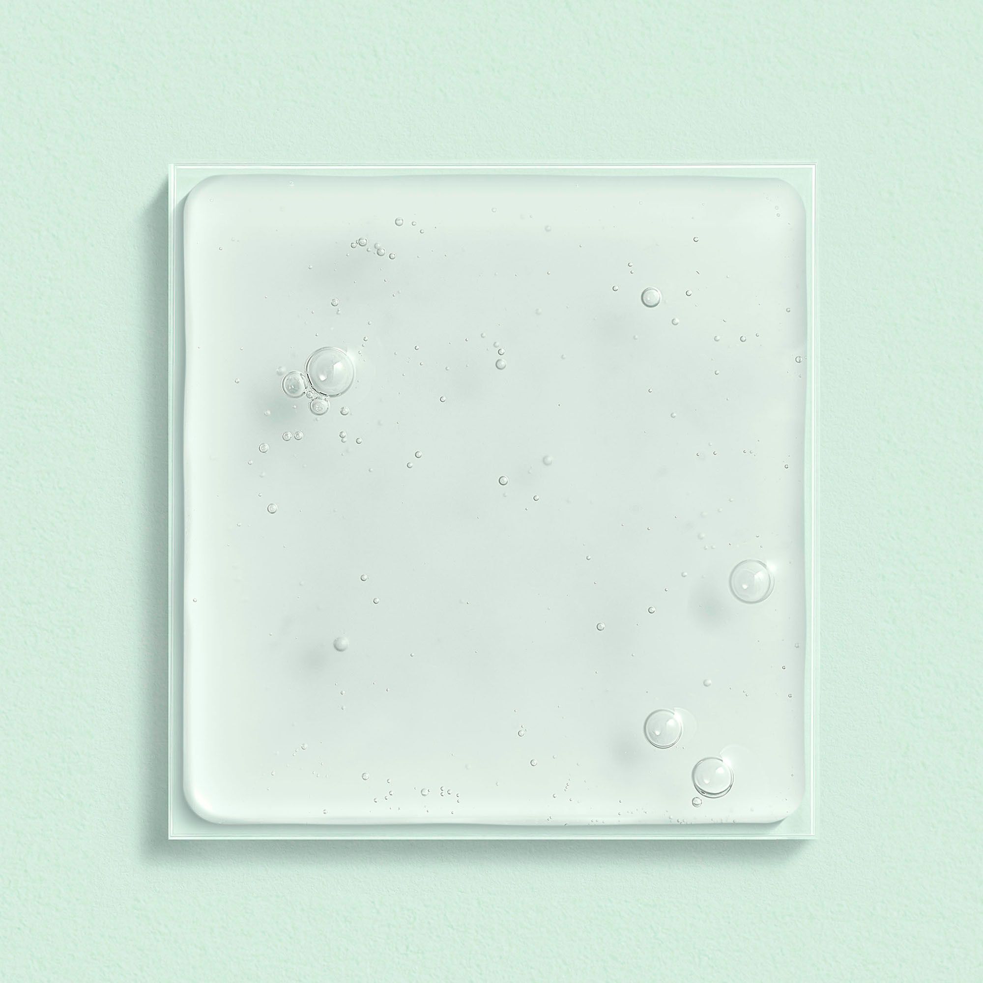Liquide transparent carré avec bulles. Sur fond blanc.