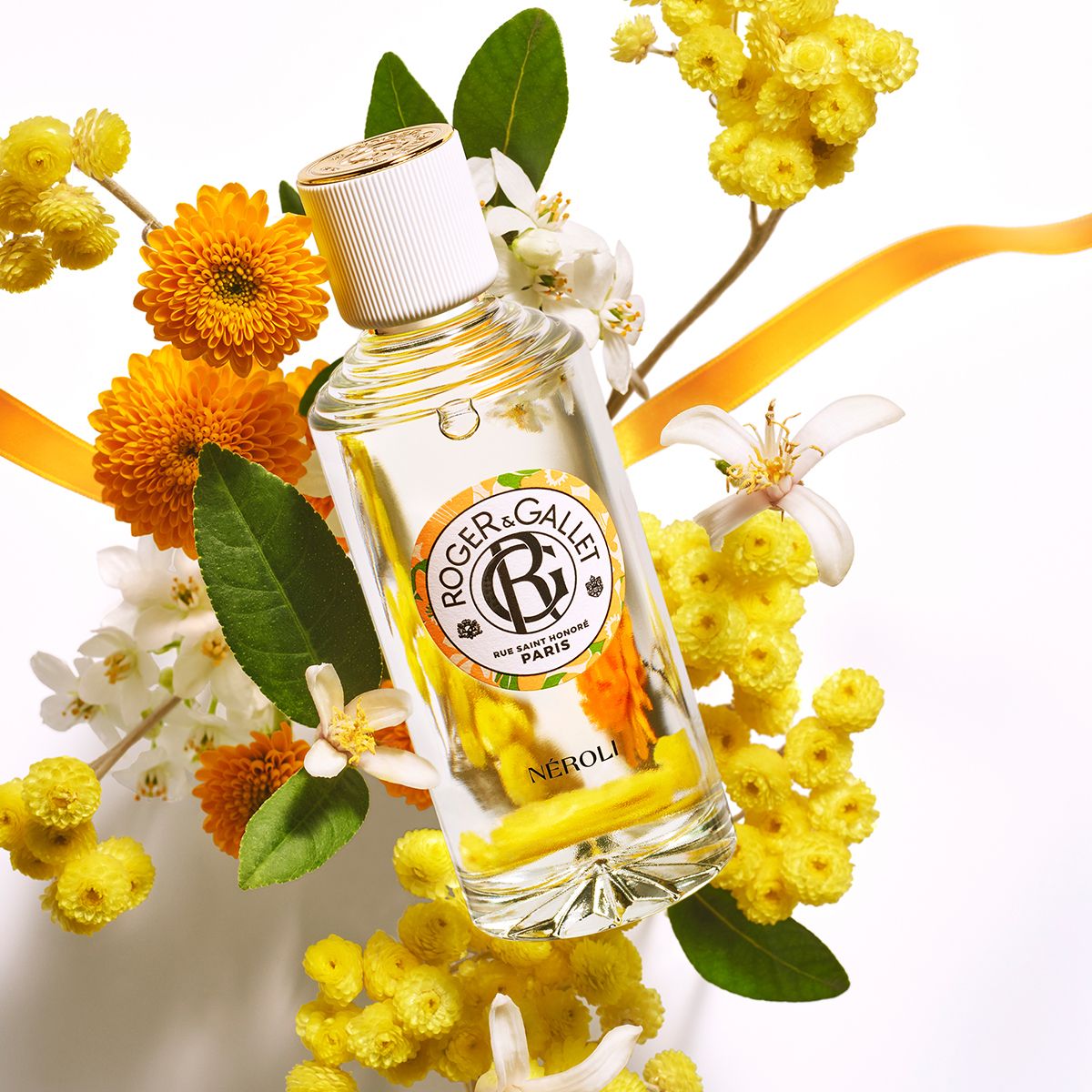 Flacon avec bouchon blanc, entouré de fleurs. Logo Roger & Gallet. Texte: Néroli.