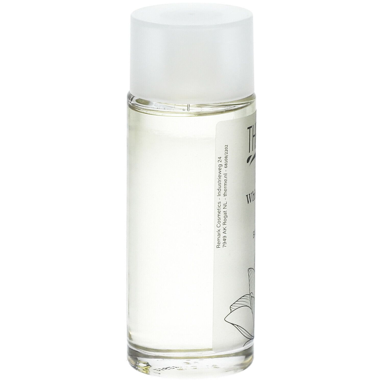 Flacon en verre avec bouchon blanc. Inscription : THERME Zen White Lotus BATH OIL. Dos avec texte et illustration de fleur de lotus.