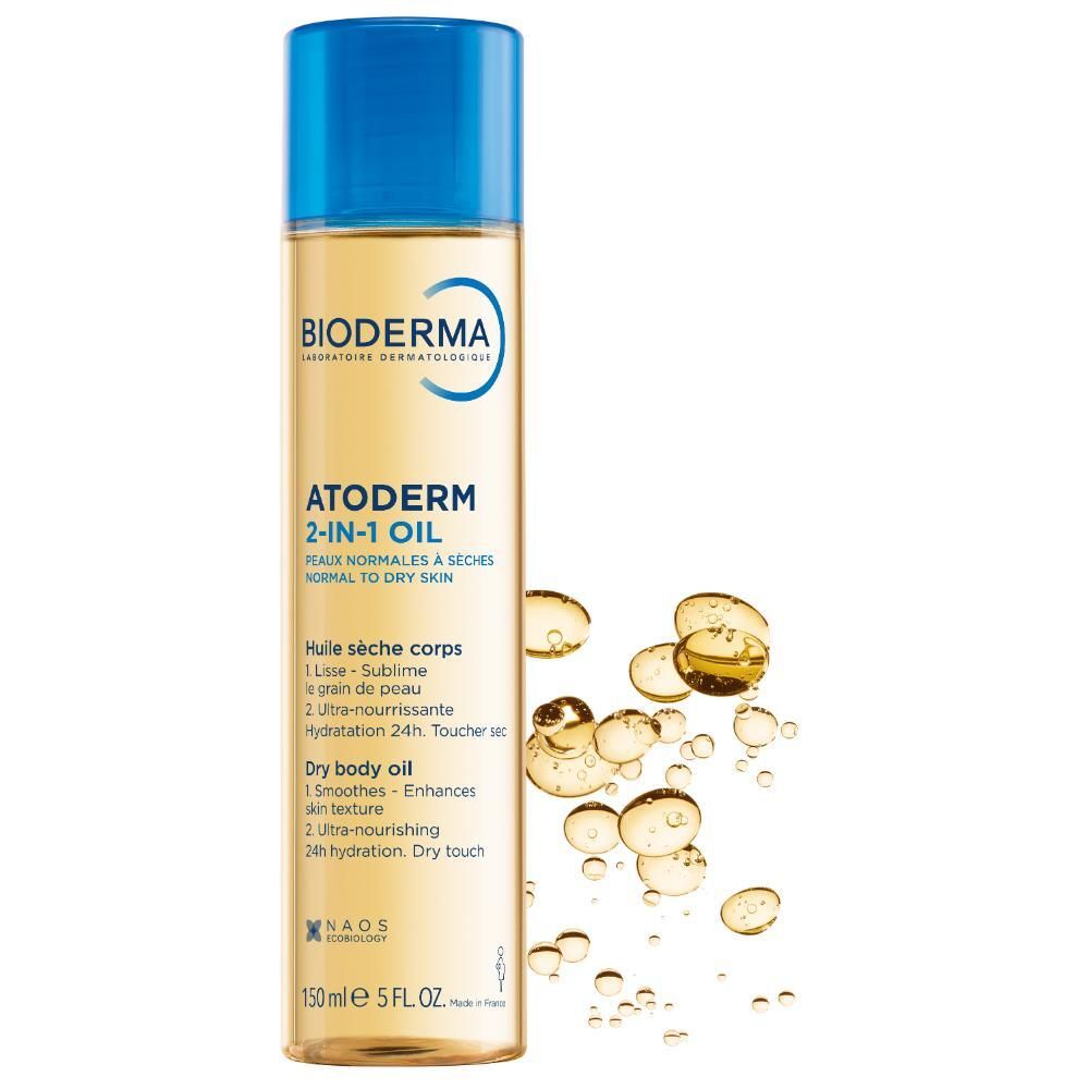 Flacon d'huile Bioderma Atoderm 2-en-1. Bouchon bleu. Liquide jaune. Étiquette avec nom et fonctions du produit.