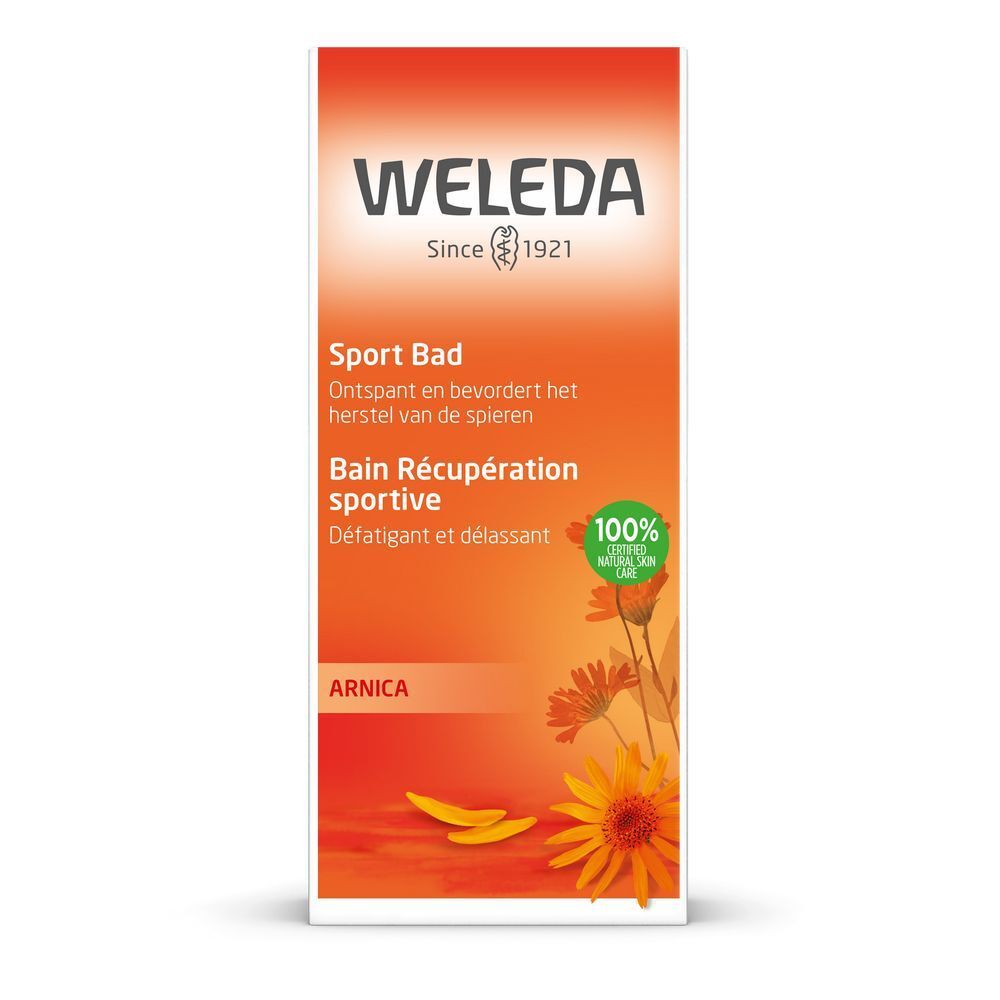 Produktverpackung mit Weleda-Logo, Produktname in Deutsch und Französisch, Arnika-Blüten-Illustration und Text.