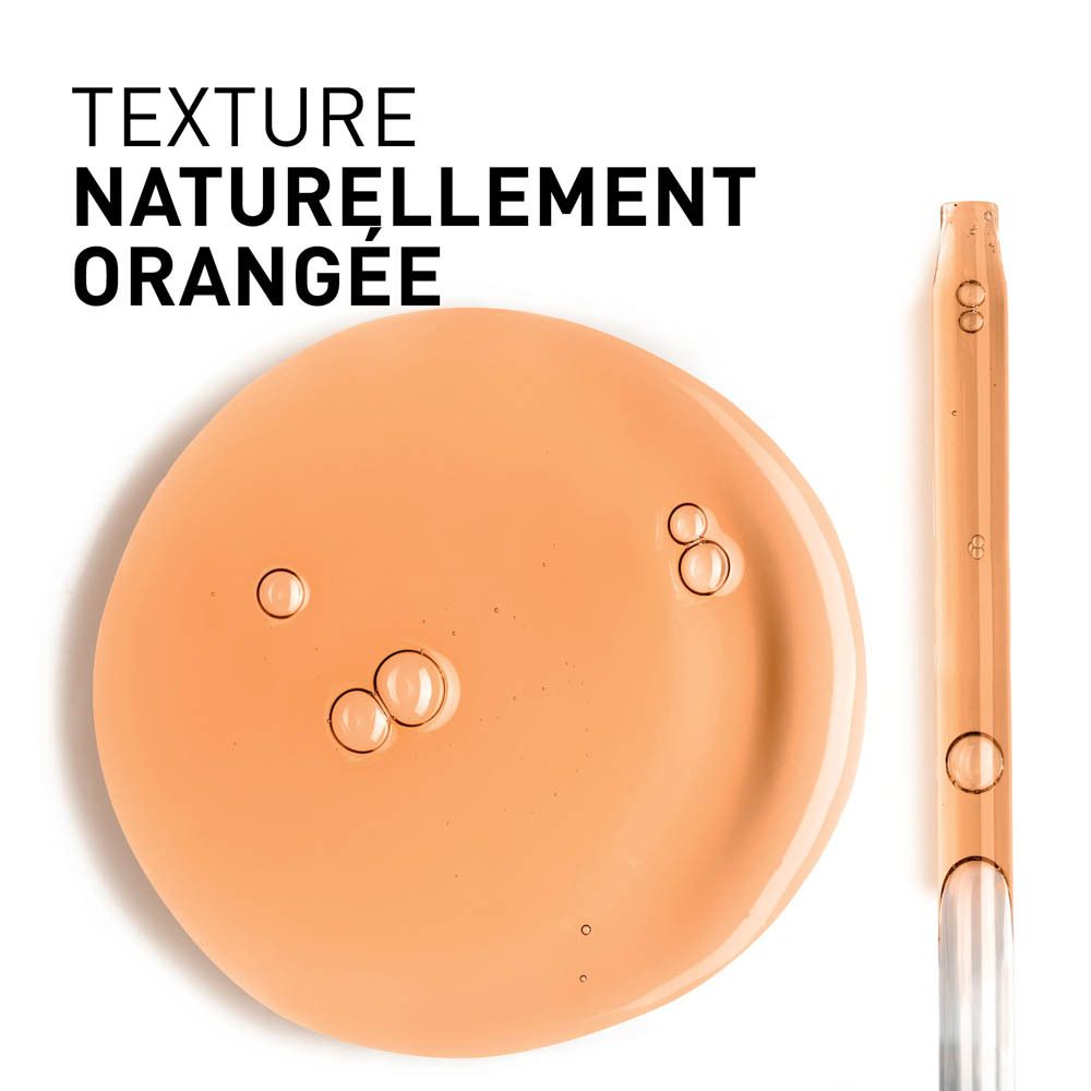 Texture de sérum orangée avec bulles. Pipette à côté.