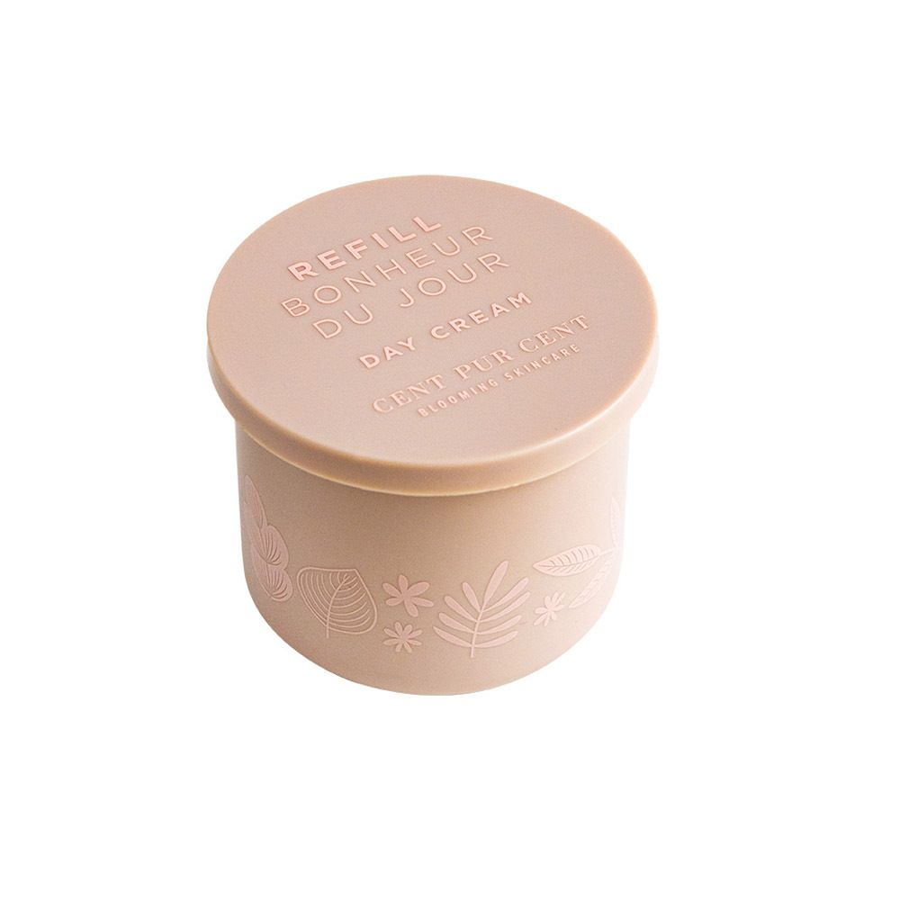 Récipient à crème beige avec couvercle. Texte sur le couvercle. Des feuilles et des fleurs sont représentées sur le récipient.