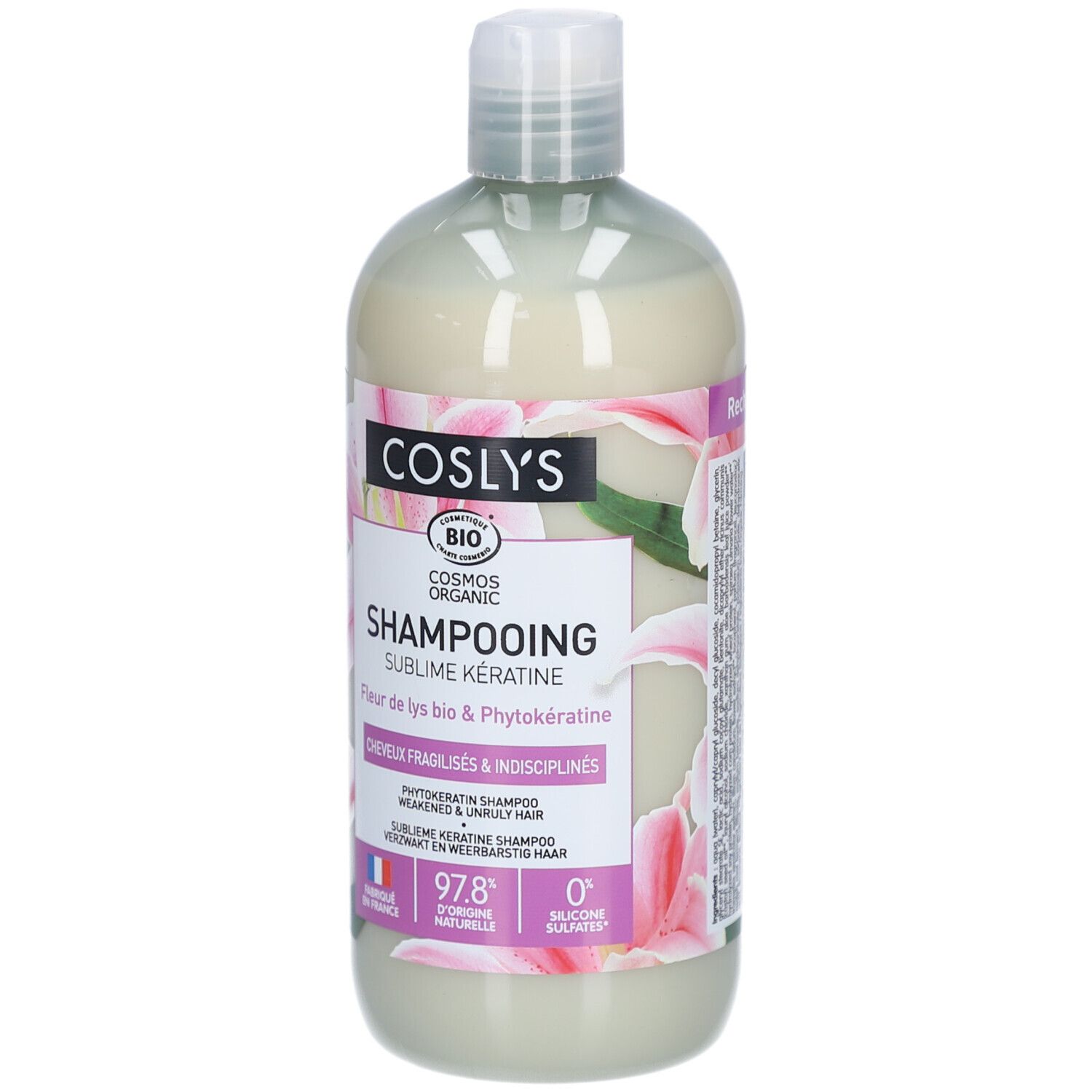 Shampoo-Flasche mit weißem Inhalt. Aufschrift: Coslys, Shampooing Sublime Kératine. Mit Bio-Siegel und Blumenmuster.