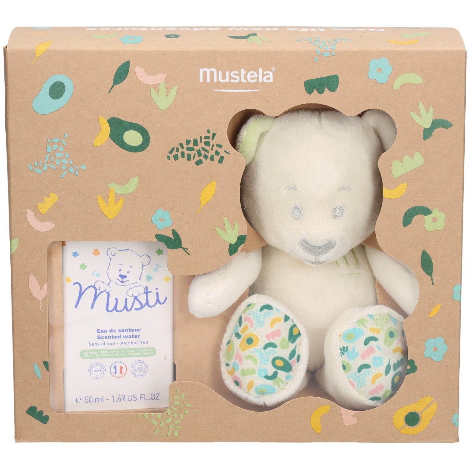 Mustela Geschenkset mit Plüschbär und Parfüm. Der Bär hat grüne Ohren und bunte Pfoten. Die Verpackung ist braun.