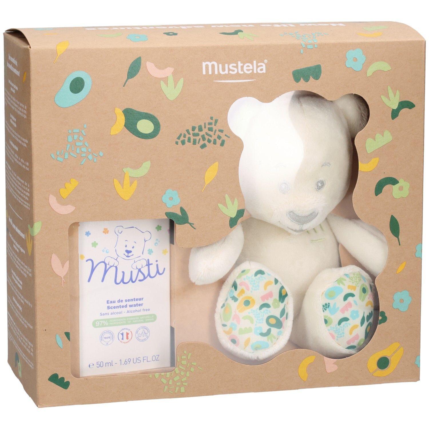 Mustela Geschenkset mit Plüschbär und Parfüm. Der Bär hat ein grünes Ohr und bunte Pfoten. Die Verpackung ist braun.