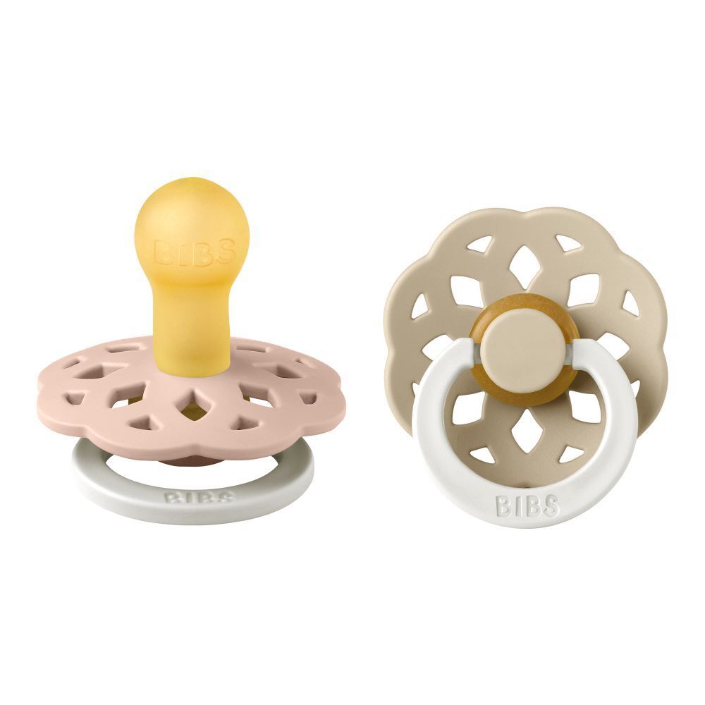 Deux sucettes. Marque BIBS. Tétine jaune, bouclier rose et beige. Motif ajouré. Anneau blanc.