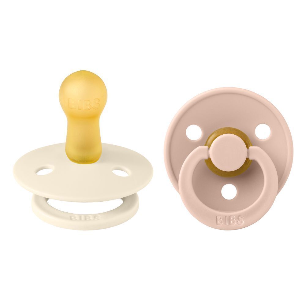 Deux sucettes. Couleurs: ivoire et rose. Marque BIBS. Forme ronde.