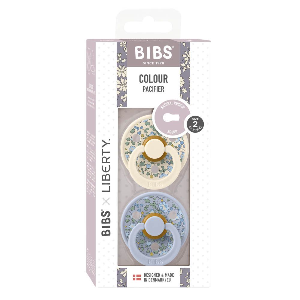 Boîte de deux sucettes BIBS x Liberty, taille 2. Sucettes bleues et crème à motifs floraux. Fabriqué au Danemark.