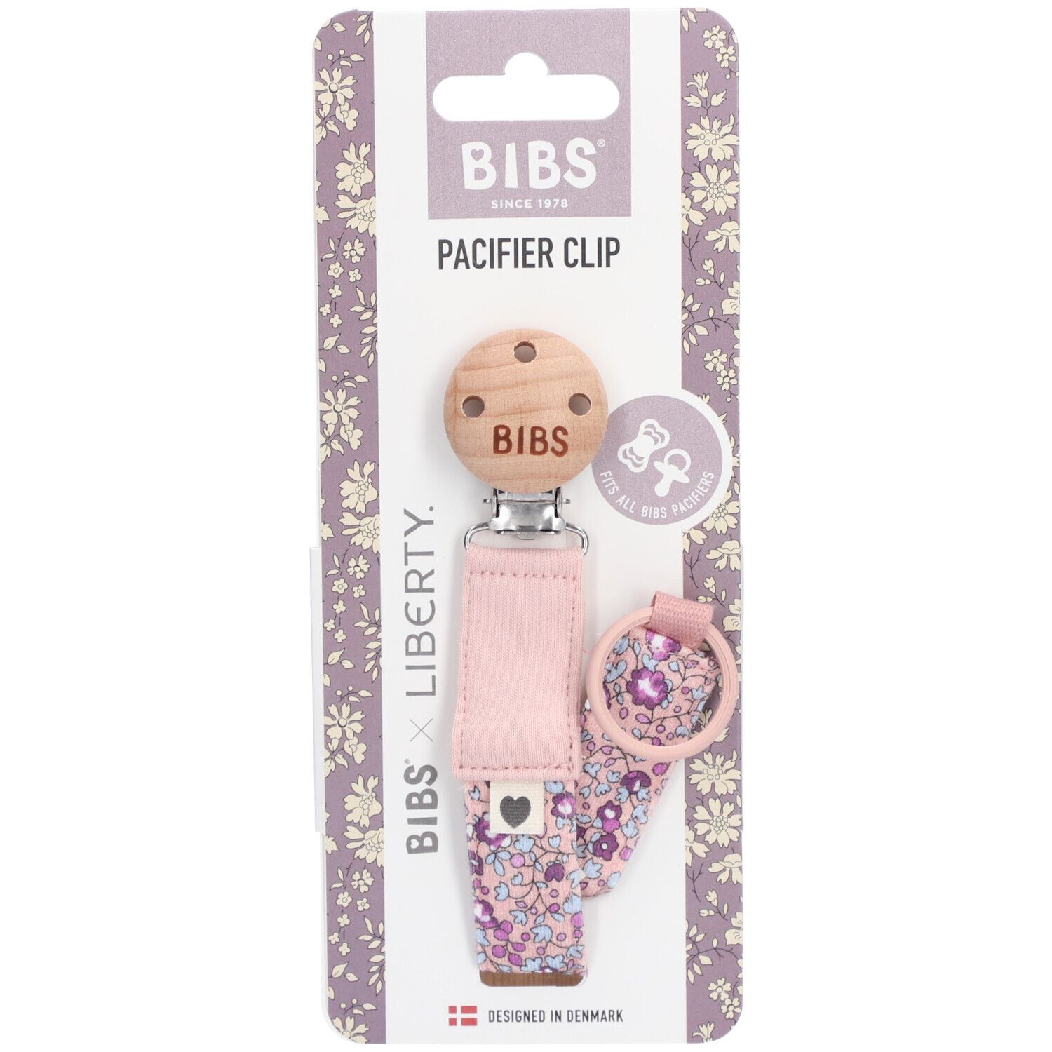 Emballage avec attache-tétine. Clip en bois avec logo BIBS. Ruban rose fleuri. BIBS x Liberty.