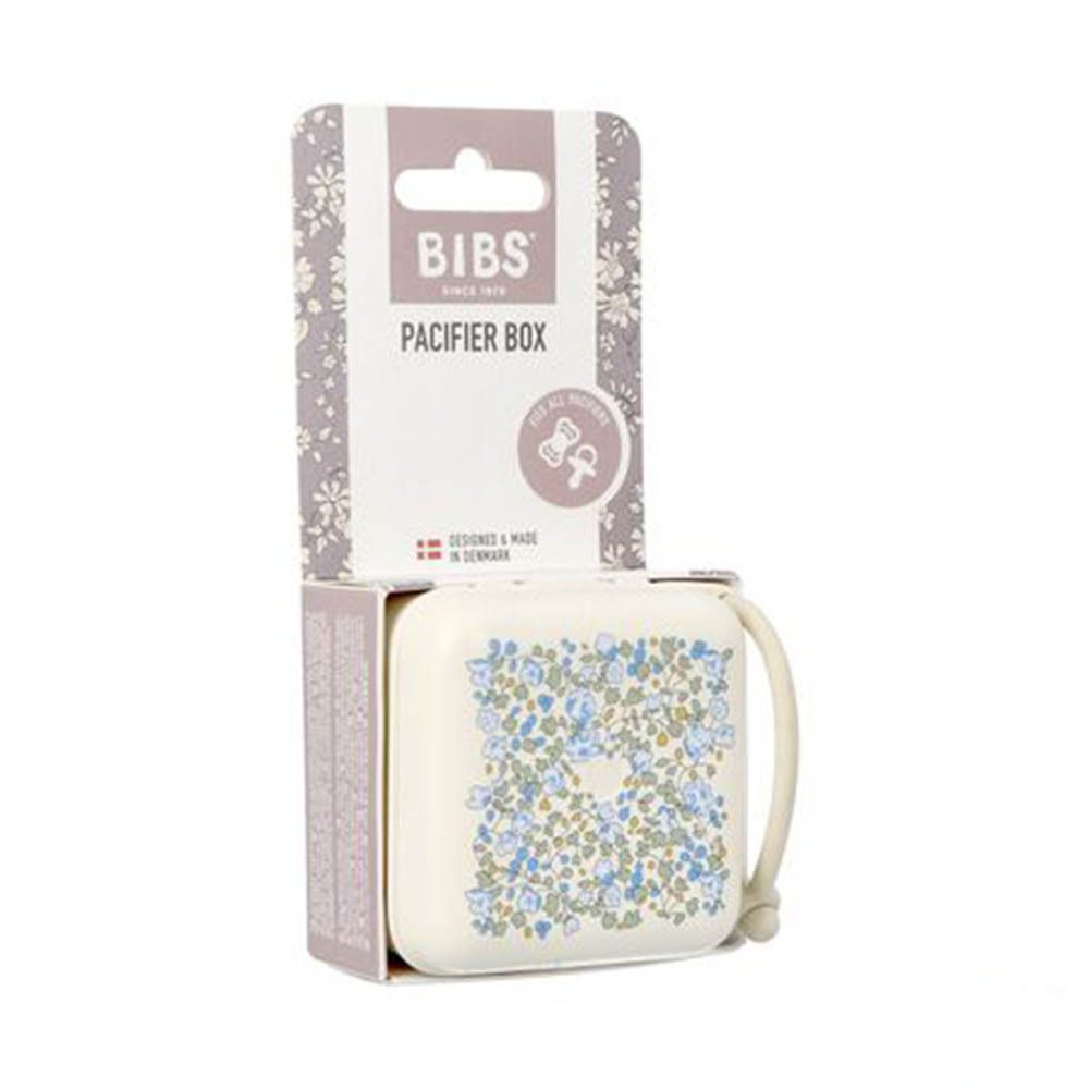 Boîte à sucette BIBS en emballage. Boîte beige avec motif floral bleu. Couvercle avec poignée. Emballage avec logo.