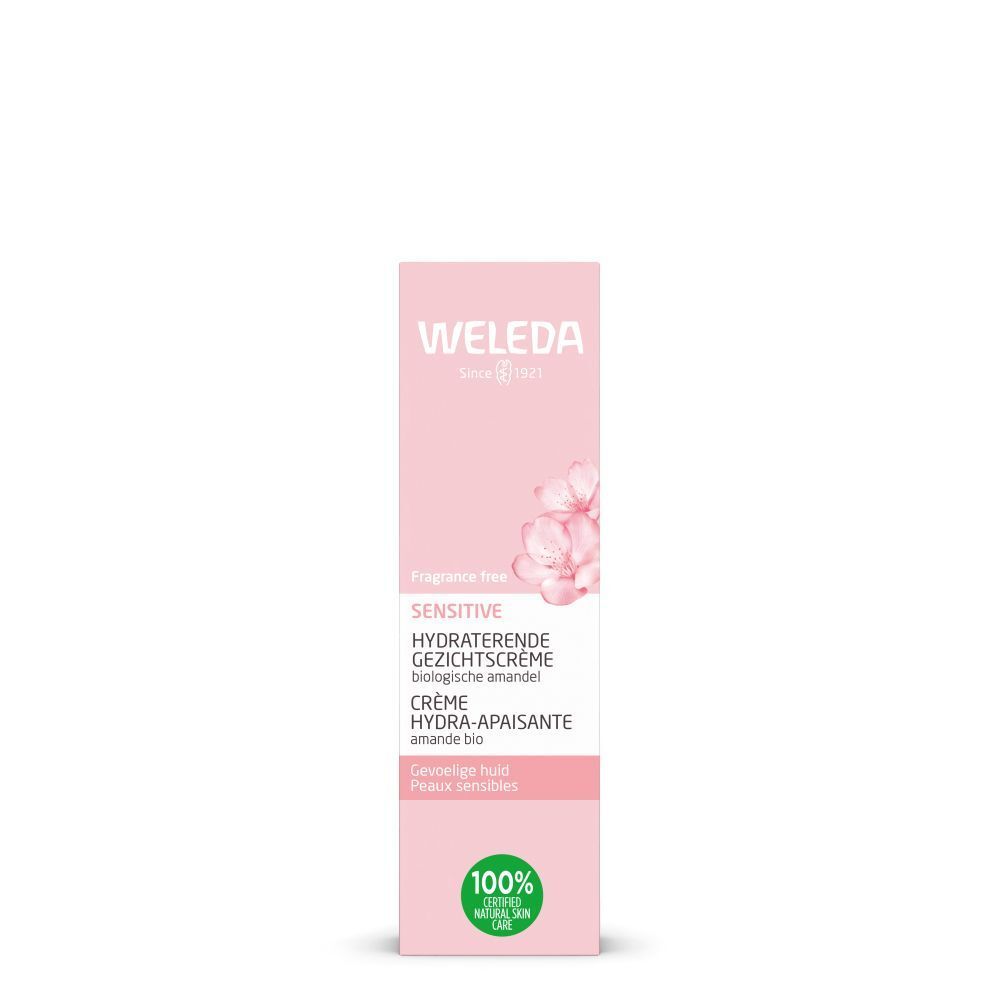 Boîte rose. Inscriptions: WELEDA, SENSITIVE, HYDRATERENDE GEZICHTSCRÈME, CRÈME HYDRA-APAISANTE. Avec fleurs.