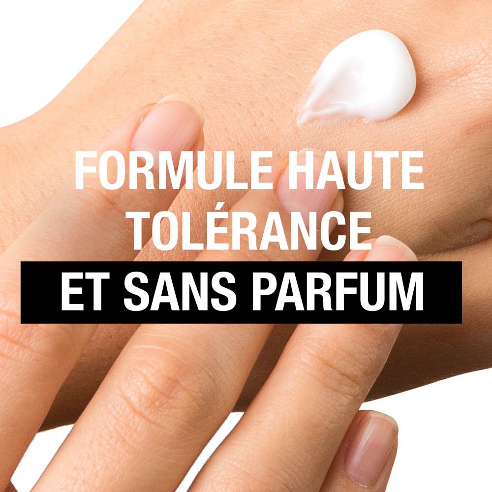 Main avec crème. Texte: Formule haute tolérance et sans parfum.