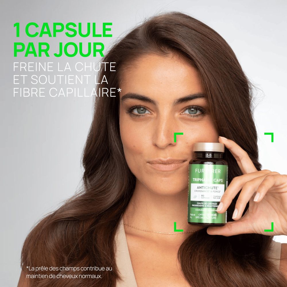 Femme tenant un flacon. Texte: 1 capsule par jour. Freine la chute et soutient la fibre capillaire.