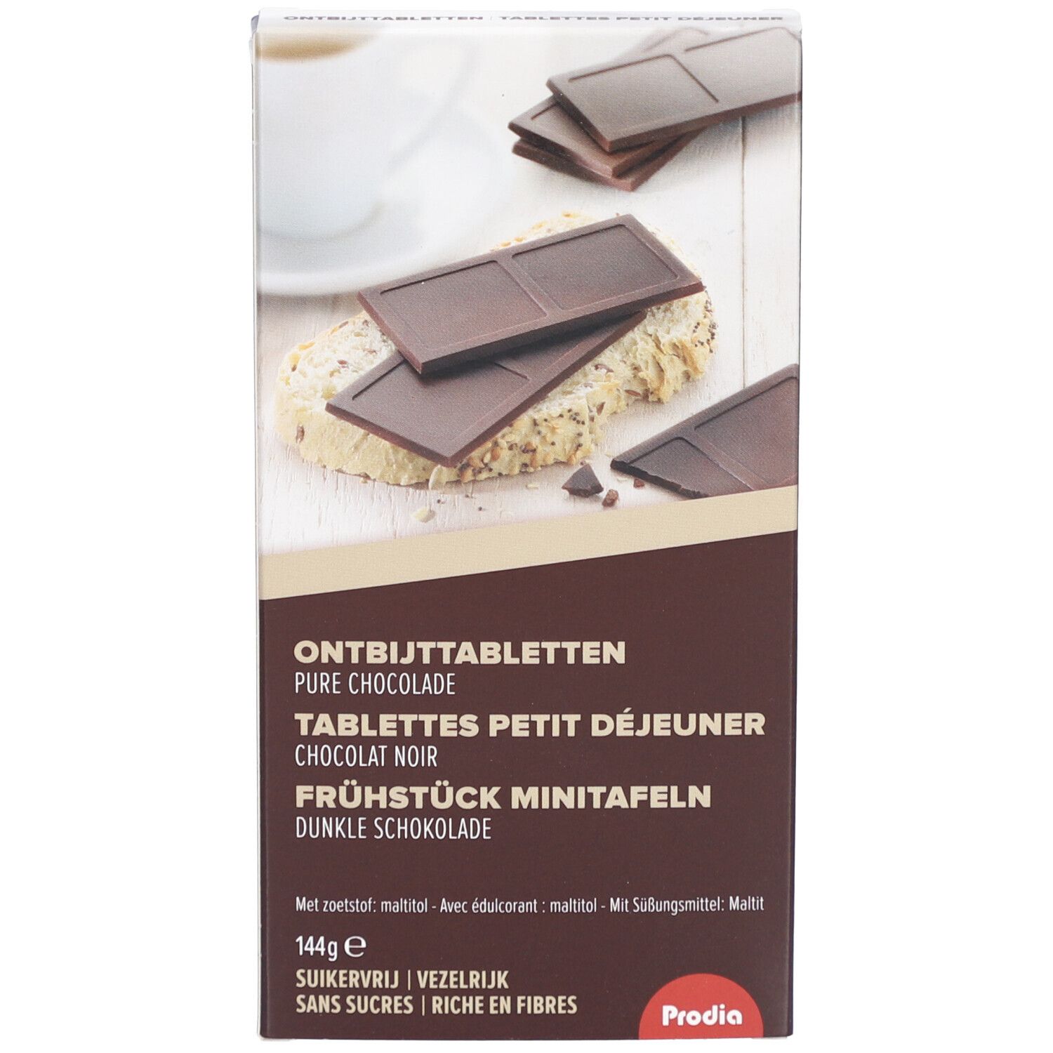Schachtel mit Schokoladentafeln. Text: Ontbijttabletten, Tablettes Petit Déjeuner, Frühstück Minitafeln. Marke: Prodia. Dunkle Schokolade, zuckerfrei, reich an Ballaststoffen.