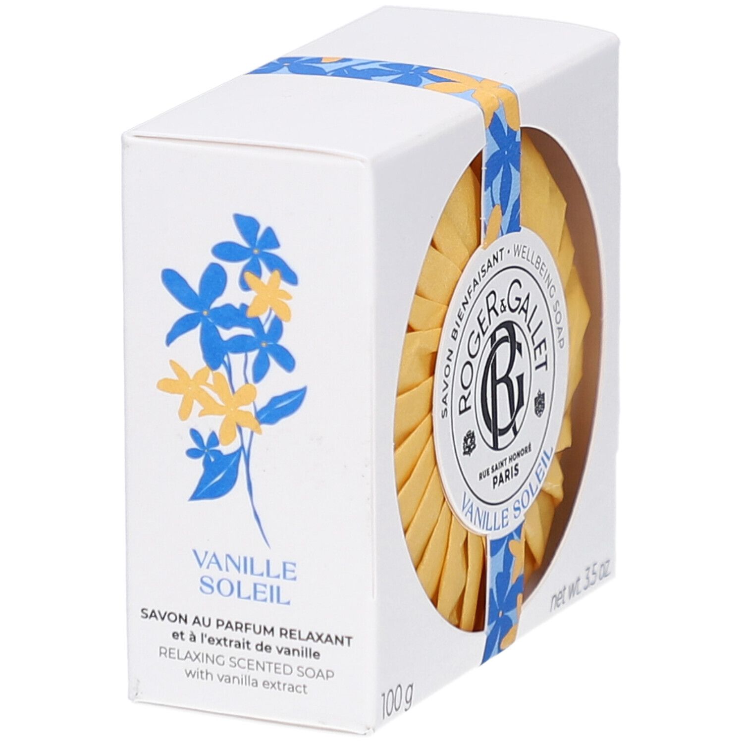 Weißer Karton mit floralem Design. Aufschrift: Vanille Soleil. Enthält ein rundes Seifenstück.