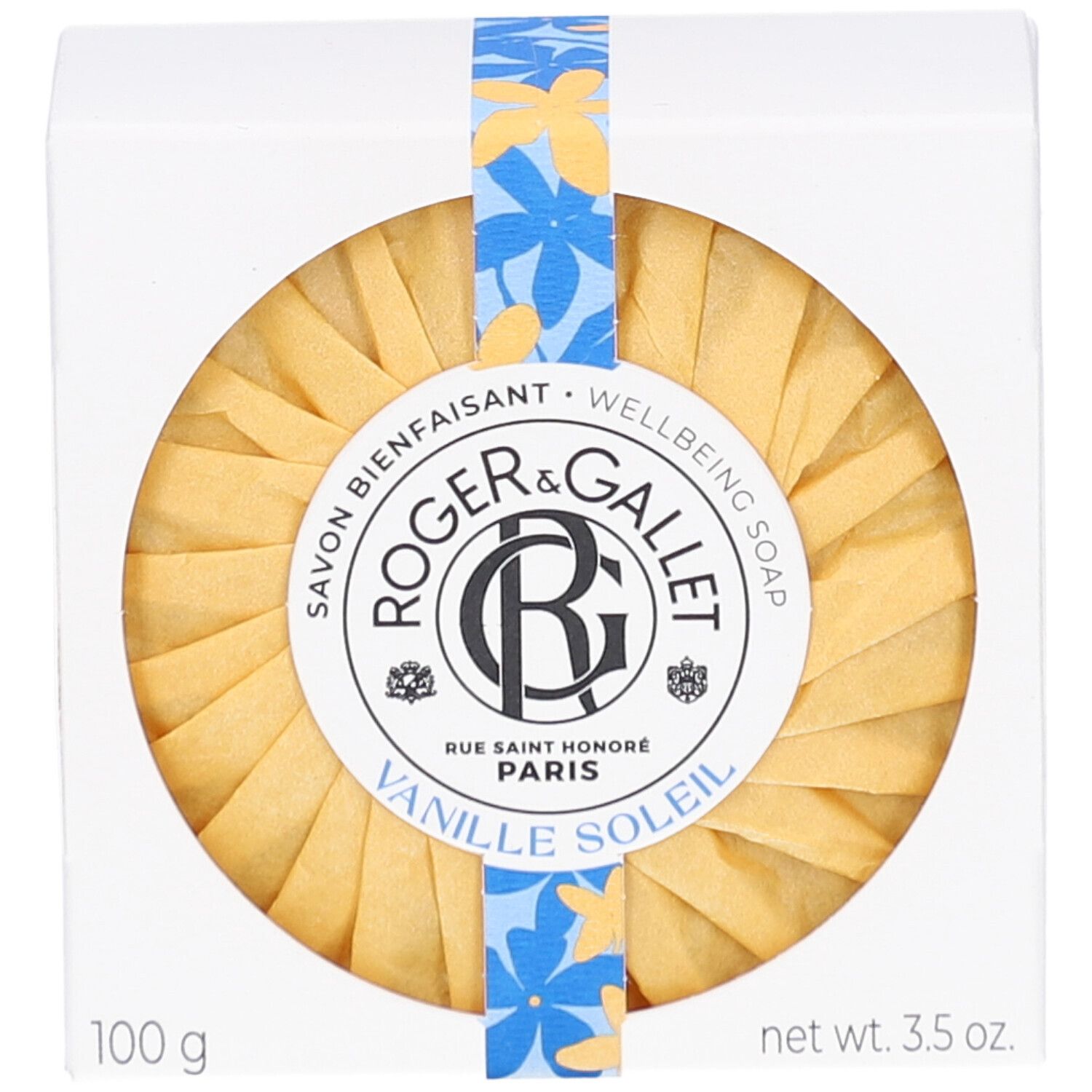 Weißer Karton mit rundem Seifenstück. Aufschrift: Roger & Gallet Vanille Soleil. Gelbe Papierverpackung.