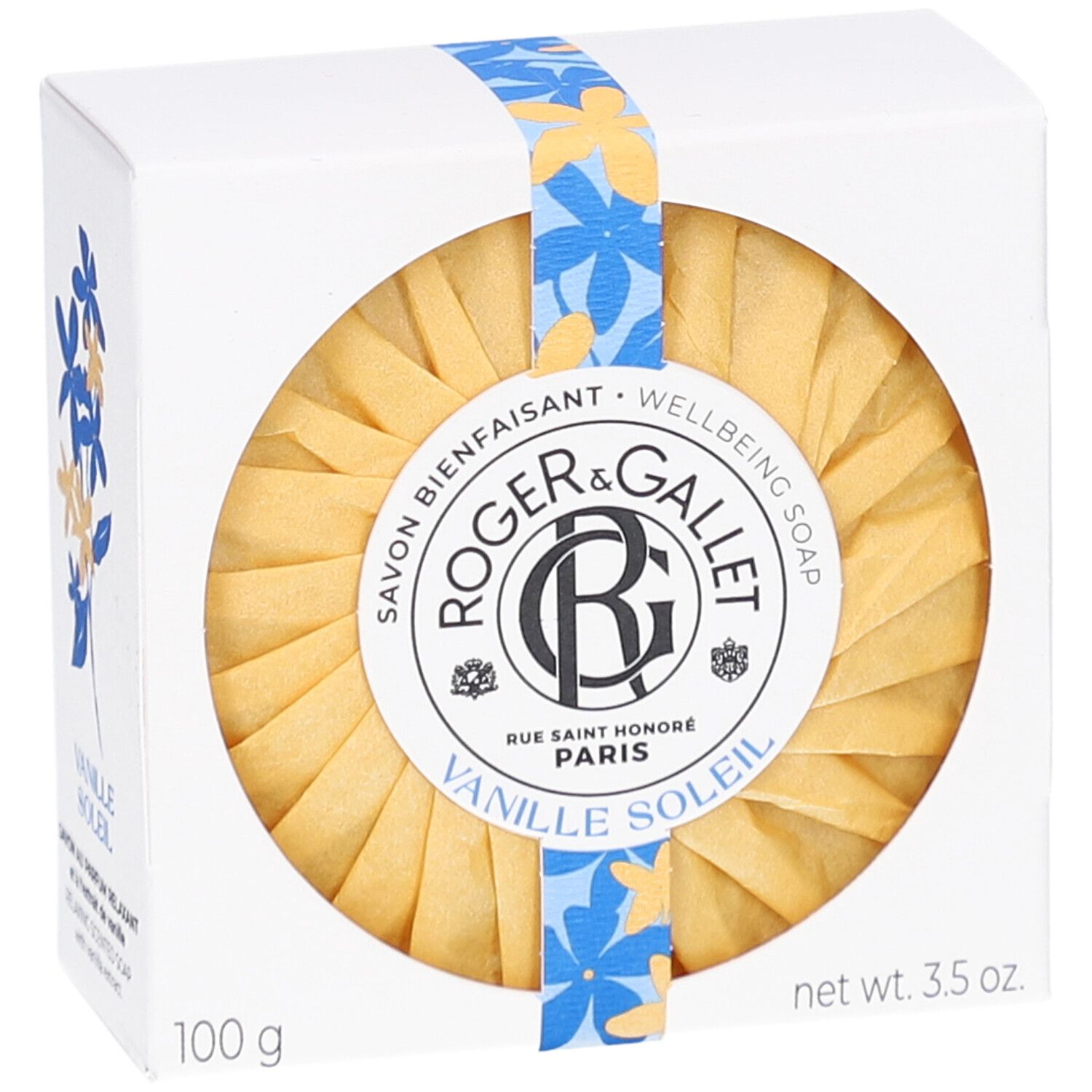 Weißer Karton mit rundem Seifenstück. Aufschrift: Roger & Gallet Vanille Soleil. Gelbe Papierverpackung.