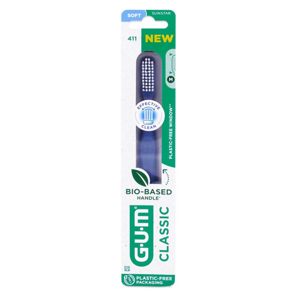 Brosse à dents GUM Classic 411, souple, dans son emballage. Manche bleu, tête blanche. Emballage avec informations.