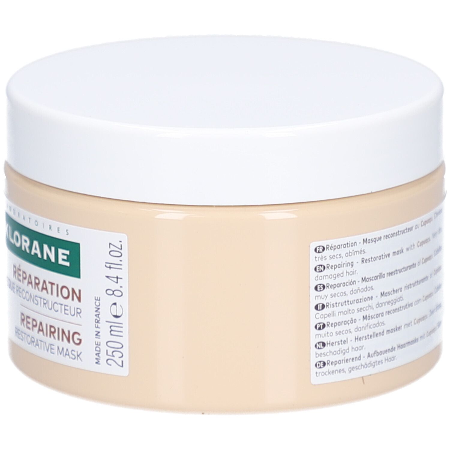 Beige Tiegel mit weißem Deckel. Aufkleber mit Text in mehreren Sprachen und Volumenangabe: 250 ml.