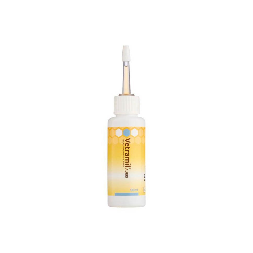 Flacon blanc avec applicateur. Inscription Vetramil Auris. Éléments de design jaunes et bleus. 50ml.