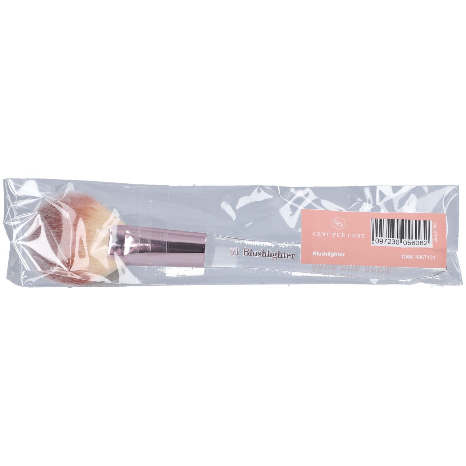 Pinceau dans un emballage plastique. Tête de pinceau rose-beige, manche transparent, manchon rose. Inscription "Blushlighter".