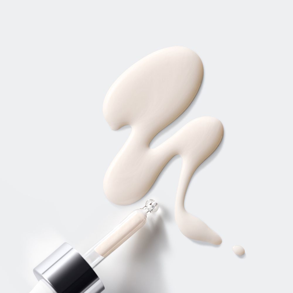 Gouttes de liquide et compte-gouttes. Le liquide est beige clair. Compte-gouttes avec col argenté.