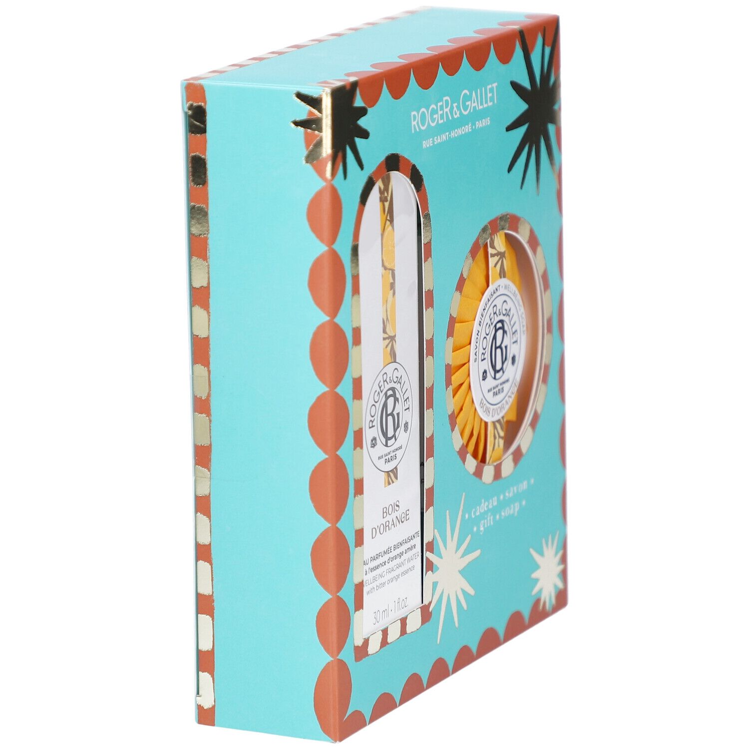 Geschenkset, schräg von der Seite gesehen. Türkisfarbene Schachtel mit orangefarbenen Details und Sternen. Logo und Produktnamen sichtbar.