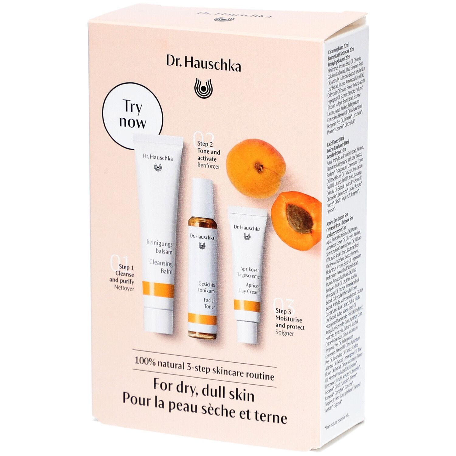 Geschenkset mit drei Hautpflegeprodukten und Aprikosen. Aufdruck: Dr. Hauschka, 3-Schritte-Routine für trockene Haut.