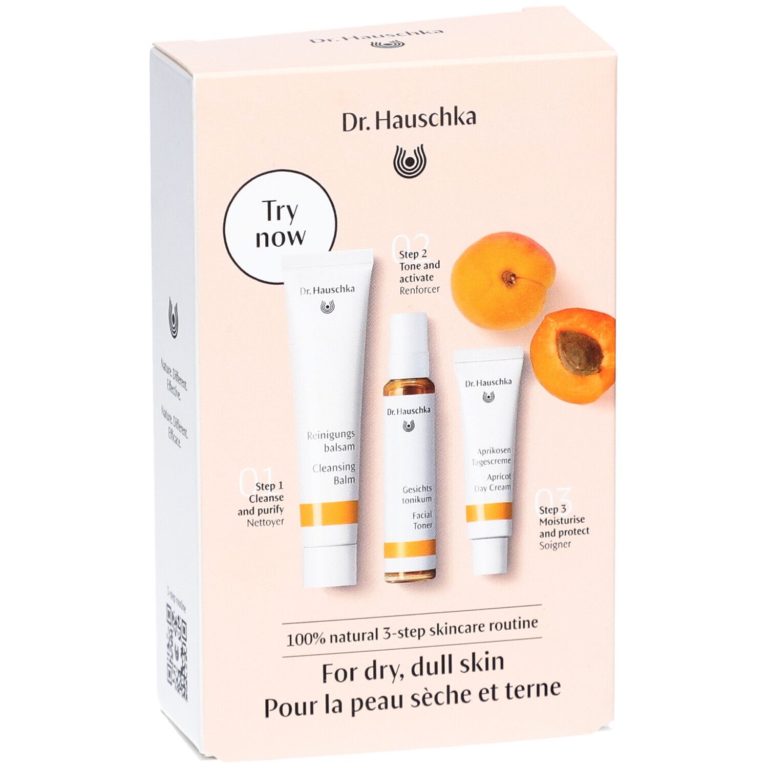 Geschenkset mit drei Hautpflegeprodukten und Aprikosen. Aufdruck: Dr. Hauschka, 3-Schritte-Routine für trockene Haut.