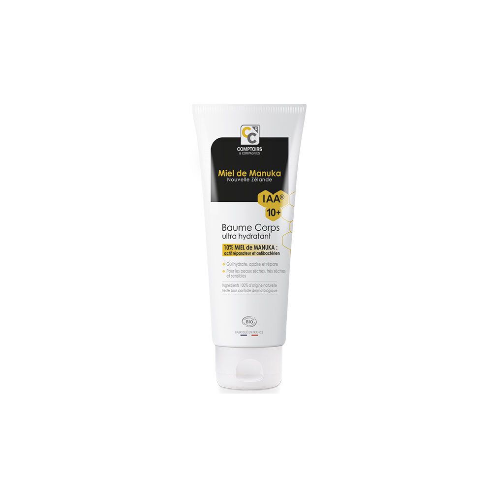 Tube blanc avec étiquette noire. Texte: Miel de Manuka, IAA 10+, Baume Corps ultra hydratant. Label Bio.