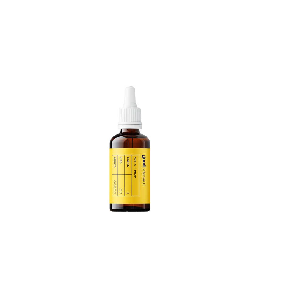 Flacon de gouttes Guud vitamine D. Flacon marron avec étiquette jaune. Pipette doseuse.