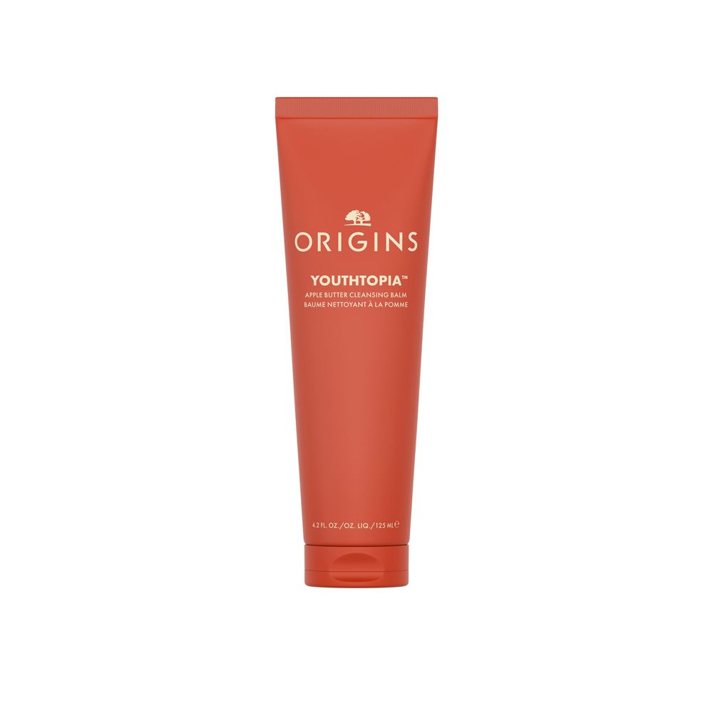 Tube rouge avec texte blanc. Inscription: ORIGINS YOUTHTOPIA Apple Butter Cleansing Balm. 125 ml.