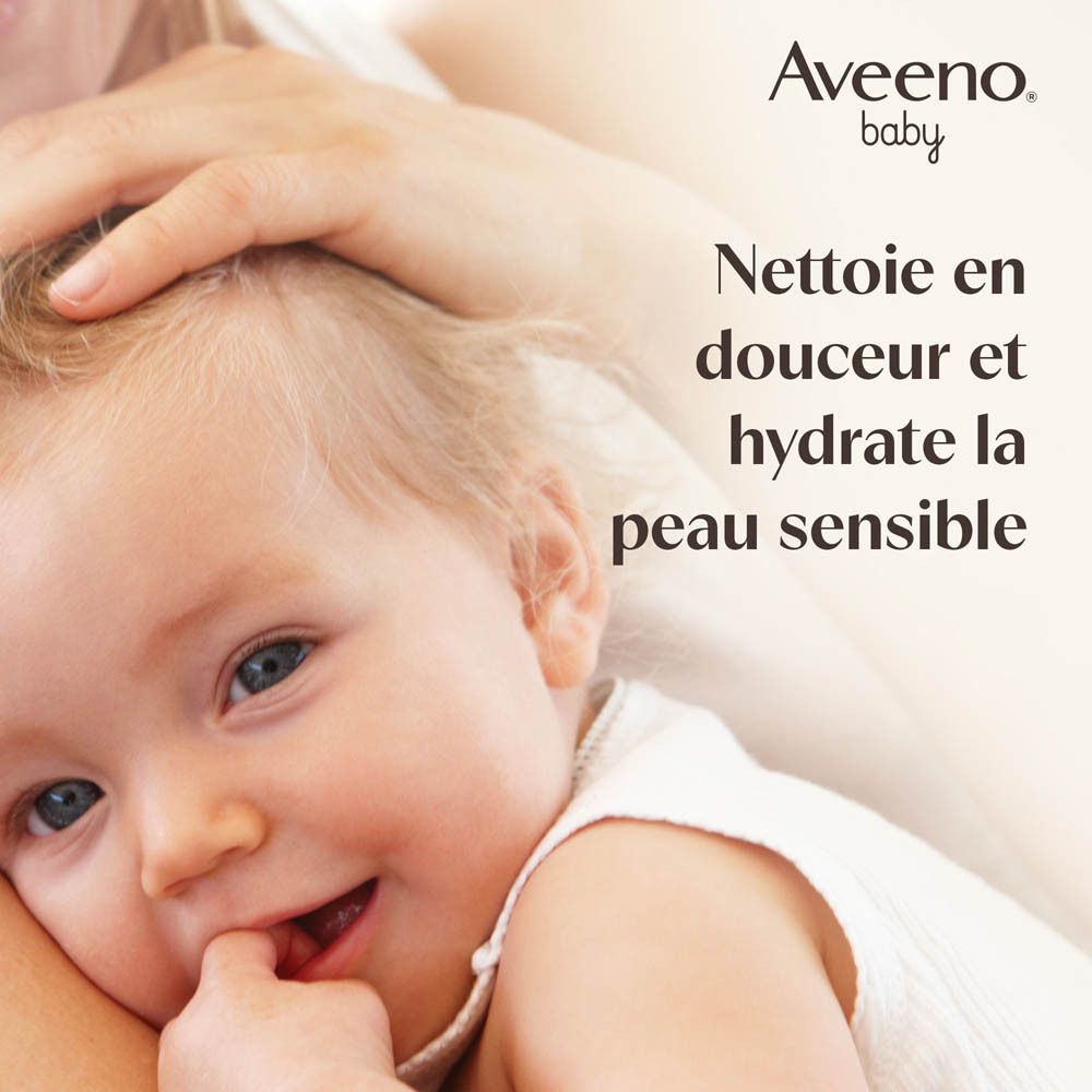 Bébé souriant, tenu par une main. Texte: Nettoie en douceur et hydrate la peau sensible.